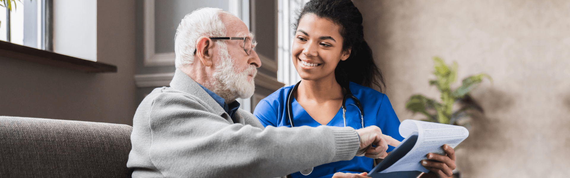 caregiver smiling to ther elderly man