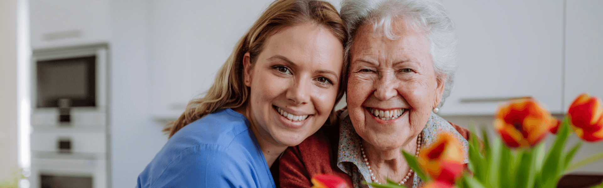 caregiver hugging the elderly woman